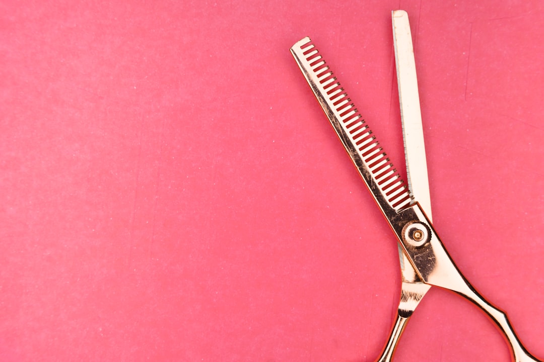 silver scissors on red textile